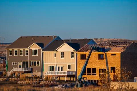 Constructing big frame house day light near sunset Stock Photos
