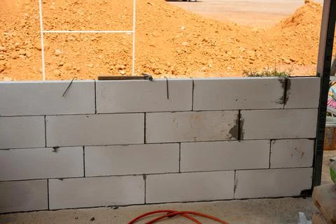 Constructing a block wall industry insights from an outdoor building project 스톡 사진