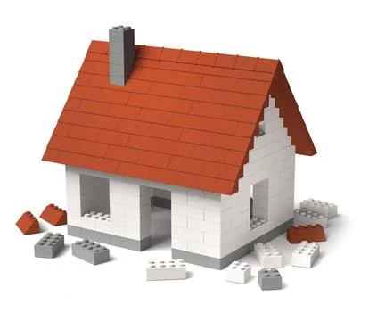 Constructing a house of toy building block tiles 3D Stock Photos