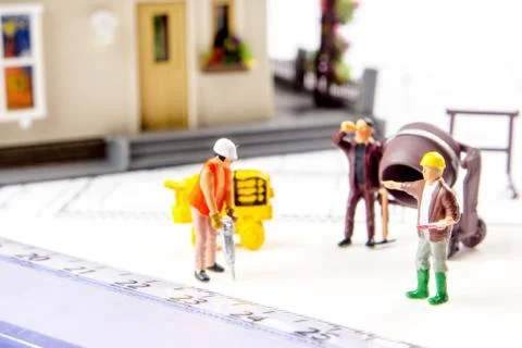 Constructing a new house with a team of workers Stock Photos