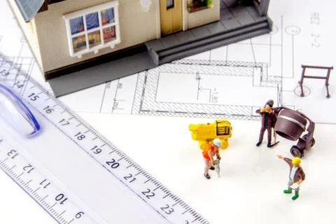 Constructing a new house with a team of workers Stock Photos