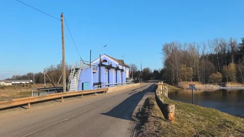 Constructing a path alongside a tranquil lake nestled in a picturesque rural set Video stock 347009411