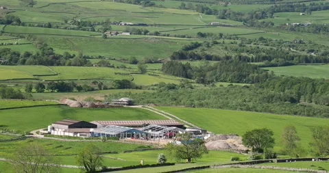 Constructing steel frame barns on a famr near Austwick, Yorkshire Dales, UK. Stock Footage 337938629