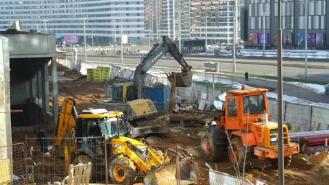 Construction activities are taking place at a site equipped with heavy machinery 動画素材 347008174