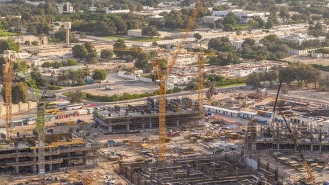 Construction activity in Dubai downtown with cranes and workers timelapse, UAE. Stock Footage 120399788