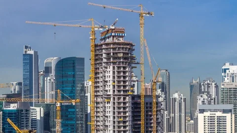 Construction activity in Dubai downtown with cranes and workers timelapse, UAE. Stock Footage 121094944