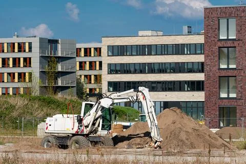 Construction activity features excavator working on a building site Stockfoto's