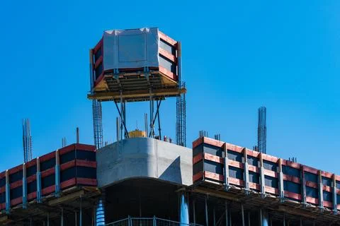 Construction activity on a high-rise building under clear sky Stock Photos