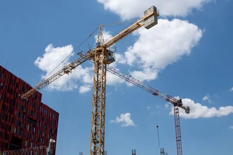 Construction Activity With Multiple Cranes Against a Bright Blue Sky in an Urban Stock Photos