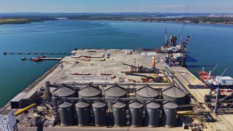 Construction activity at port facility in coastal area near water Video stock 338403865
