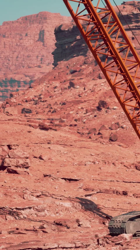 Construction activity takes place in rocky terrain with a crane at work Stock Footage 340890528