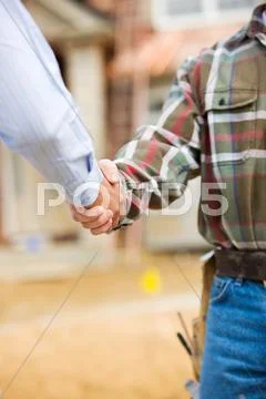 Construction: agent and contractor shake hands Stock Photos