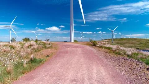 Construction and assembly of wind generators in fields with meadows and lakes Foto stock
