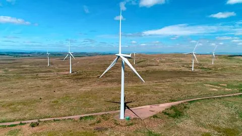 Construction and assembly of wind generators in fields with meadows and lakes Stock Photos