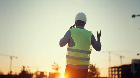 Construction and development, architect or engineer talking by phone, back view Stock Footage 318342941
