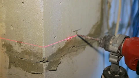 Construction and installation work. drilling a brick wall by laser level Video stock 102167104