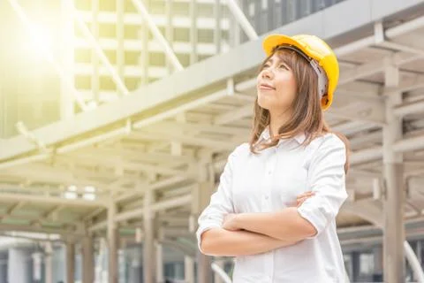 Construction and maintenance Think Big concept Female architect in yellow helmet Stockfoto's