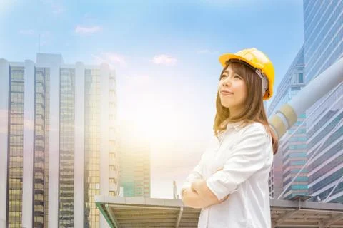 Construction and maintenance Think Big concept Female architect in yellow helmet Photos