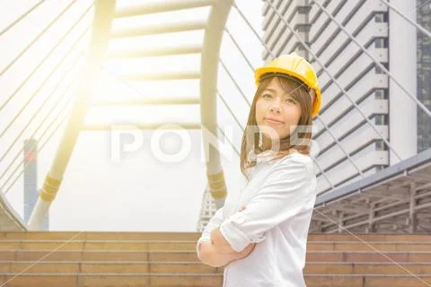 Construction and maintenance Think Big concept Female architect in yellow helmet Stock Photos
