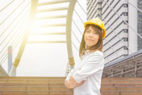 Construction and maintenance Think Big concept Female architect in yellow helmet Stockfoto's