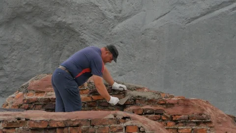Construction and restoration work. Man works on brickwork 5 Stock Footage 118369545