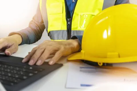 Construction and system engineers enter work data and draw drawings on the .. Stock Photos