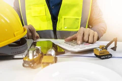 Construction and system engineers sit in their offices and check budgets an.. Stock Photos