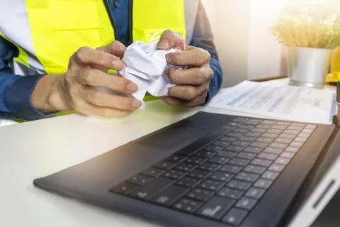 Construction and system engineers sit in their offices and crumple papers, .. Stock Photos