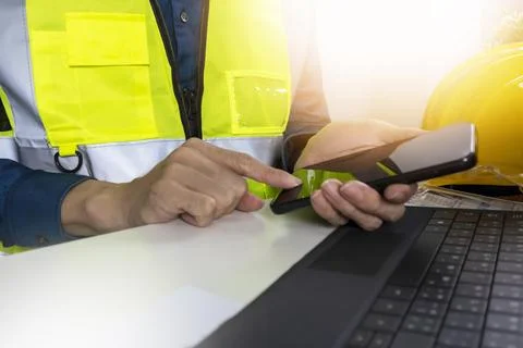Construction and system engineers use mobile phones to receive data from cu.. Stock Photos