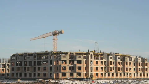 Construction of an apartment building in winter Stock Footage 129367998
