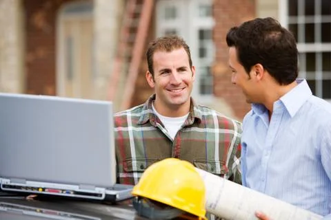 Construction: architect and builder review plans Stock Photos