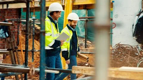 Construction, architect and manager talk on site for project planning Stock Photos