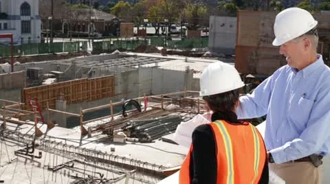Construction Architect Discusses Plans with Construction Forewoman Worker Stock Footage 20464025