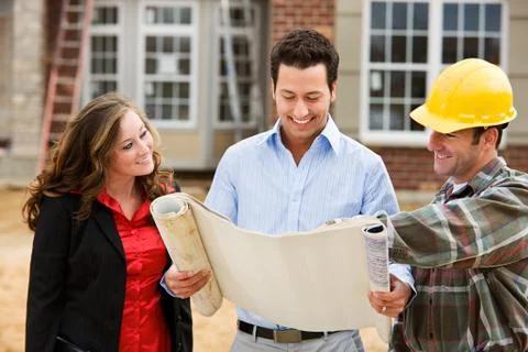 Construction: architect reviews plans with builder Stock Photos