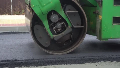 Construction of asphalt roads using an asphalt paver Stock Footage 321823946