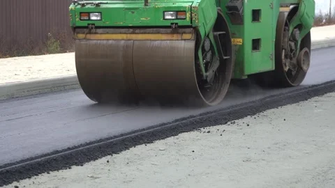 Construction of asphalt roads using an asphalt paver Stock Footage 321823988