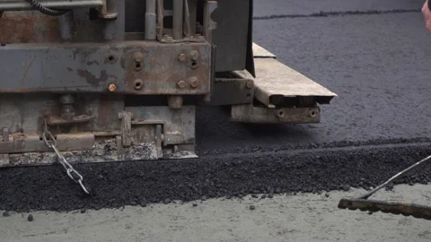 Construction of asphalt roads using an asphalt paver Stock Footage 321824027