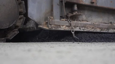 Construction of asphalt roads using an asphalt paver Stock Footage 321824280