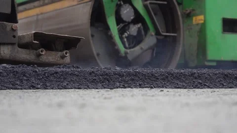 Construction of asphalt roads using an asphalt paver Stock Footage 321824667