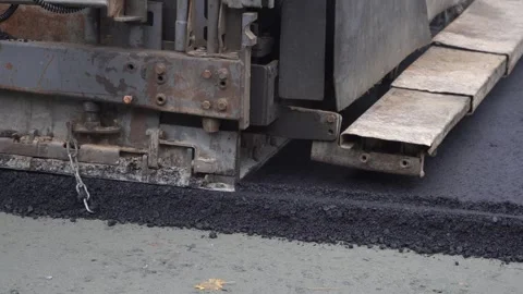 Construction of asphalt roads using an asphalt paver Stock Footage 321825207