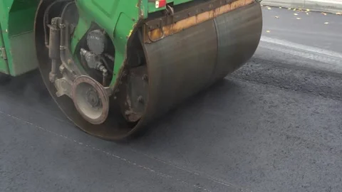 Construction of asphalt roads using an asphalt paver Stock Footage 321825253