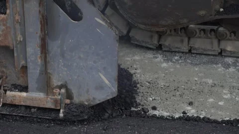 Construction of asphalt roads using an asphalt paver Stock Footage 321825655