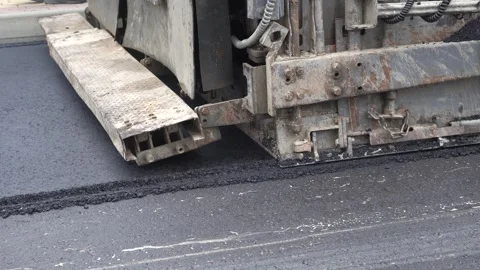 Construction of asphalt roads using an asphalt paver Stock Footage 321825681