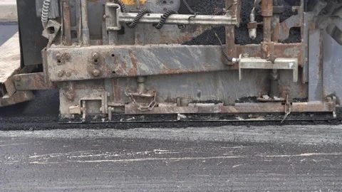 Construction of asphalt roads using an asphalt paver Stock Footage 321825745