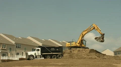 Construction Backhoe Digger Filling Dumptrucks with Dirt Timelapse 4K Stock Footage 40948016