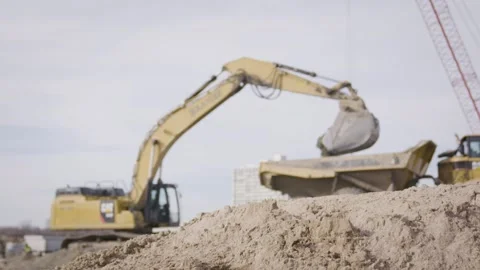 Construction Backhoe Empties Contents Into Dump Truck Slow Motion Stock Footage 144904919