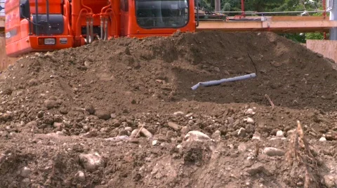 Construction, backhoe scooping dirt, #2 tight frame Stock Footage