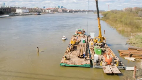 Construction barge on the river in the city. Loading of building materials. Видео 239053254