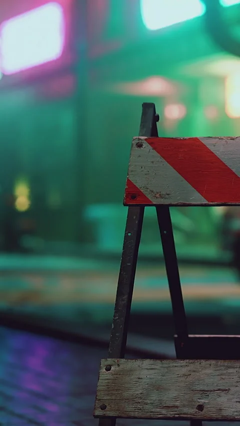 Construction barrier in urban area at night with neon lights in background Stock Footage 340266111