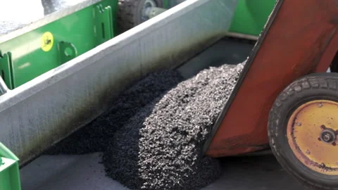 Construction. The black substance pours out of the wheelbarrows. Construction of Video stock 178510402